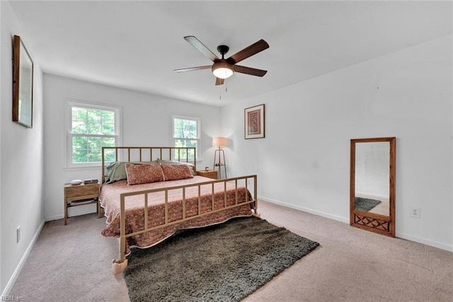 bedroom with light carpet and ceiling fan