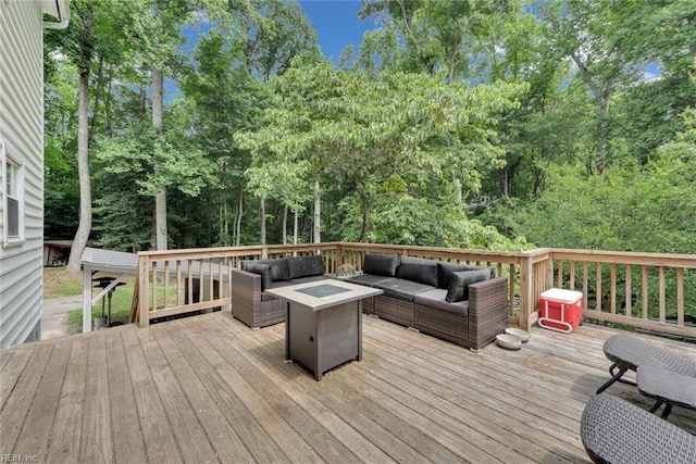 wooden terrace with an outdoor living space with a fire pit