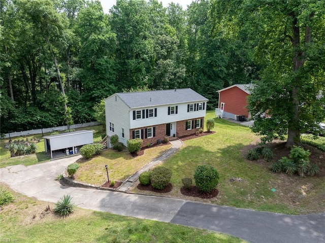 view of front facade featuring a front lawn and a carport