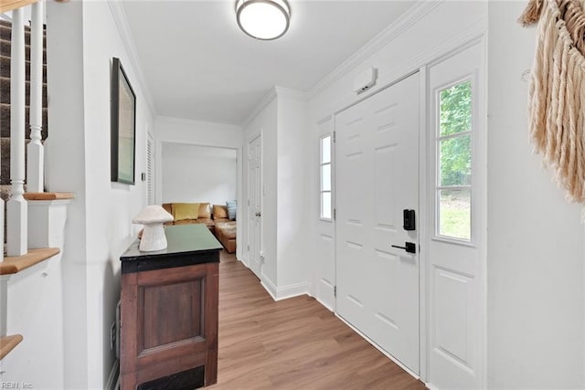 foyer entrance featuring ornamental molding and light hardwood / wood-style floors