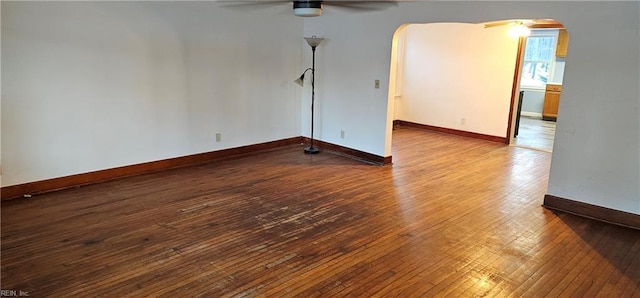 empty room with hardwood / wood-style floors and ceiling fan