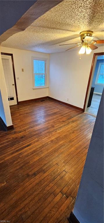 interior space with dark hardwood / wood-style flooring and ceiling fan