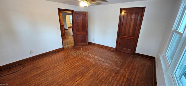 spare room with dark hardwood / wood-style floors and ceiling fan