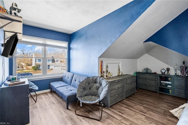 sitting room featuring hardwood / wood-style flooring and vaulted ceiling