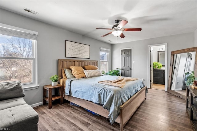 bedroom featuring ceiling fan, connected bathroom, and hardwood / wood-style flooring