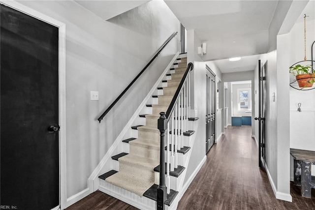 stairway with hardwood / wood-style floors