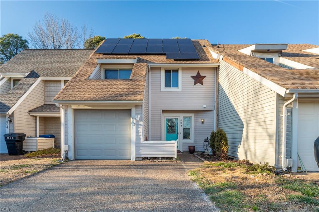 view of front of home with solar panels and a garage