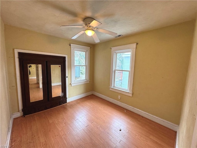 unfurnished room featuring ceiling fan and hardwood / wood-style floors