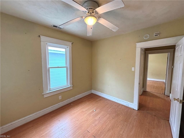 spare room with ceiling fan and light hardwood / wood-style flooring