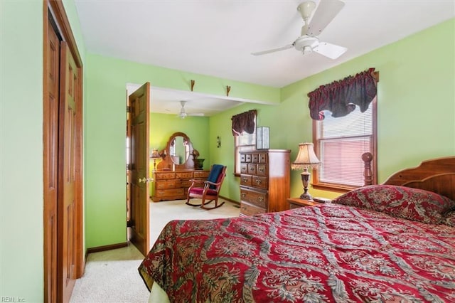 bedroom with light carpet, ceiling fan, and a closet