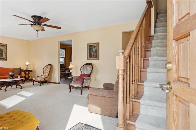 living room with light colored carpet and ceiling fan