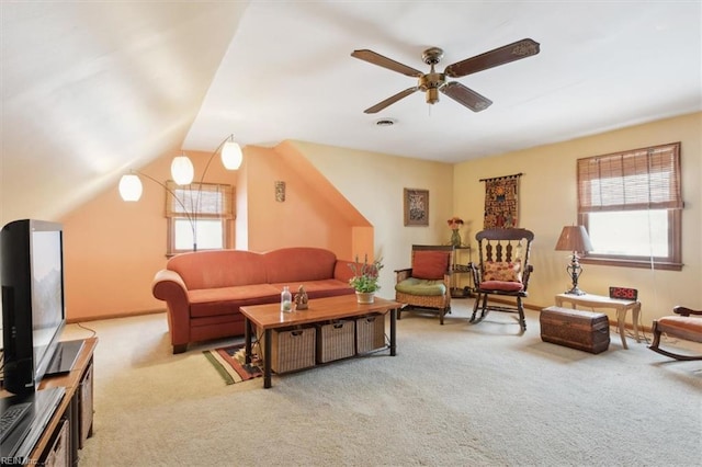 living room featuring ceiling fan, lofted ceiling, light carpet, and a wealth of natural light