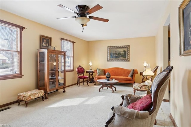 living room featuring light carpet, a wealth of natural light, and ceiling fan