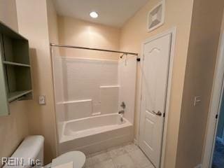 bathroom with shower / bath combination and toilet