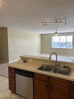 kitchen featuring dishwasher, sink, and light tile patterned floors