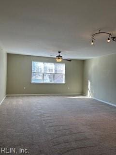 spare room with ceiling fan, track lighting, and carpet flooring