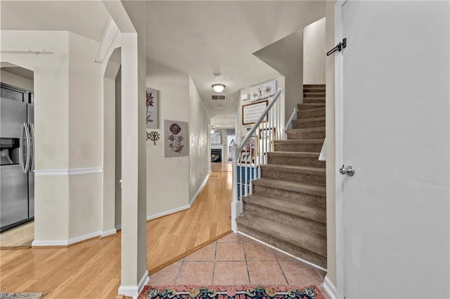 stairway with tile patterned flooring