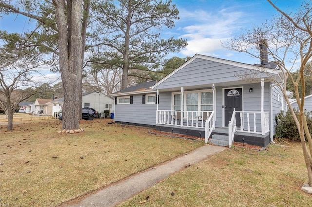 bungalow with a front yard and covered porch