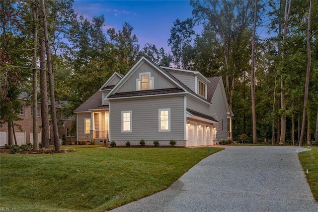 view of front facade featuring a garage and a lawn