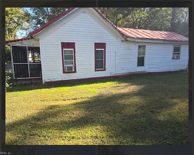 view of home's exterior with a sunroom, a yard, and cooling unit