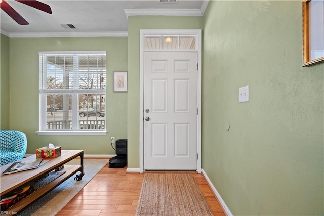 entryway with ornamental molding, hardwood / wood-style floors, and ceiling fan