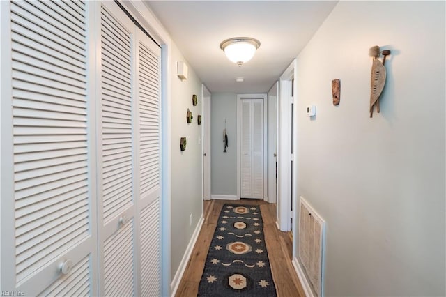 corridor featuring dark hardwood / wood-style floors