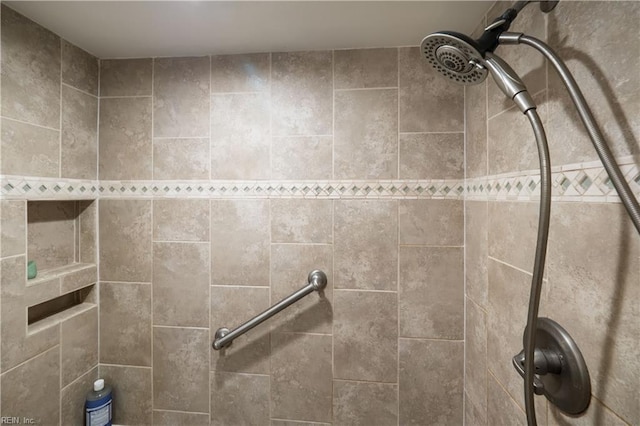 interior details featuring a tile shower