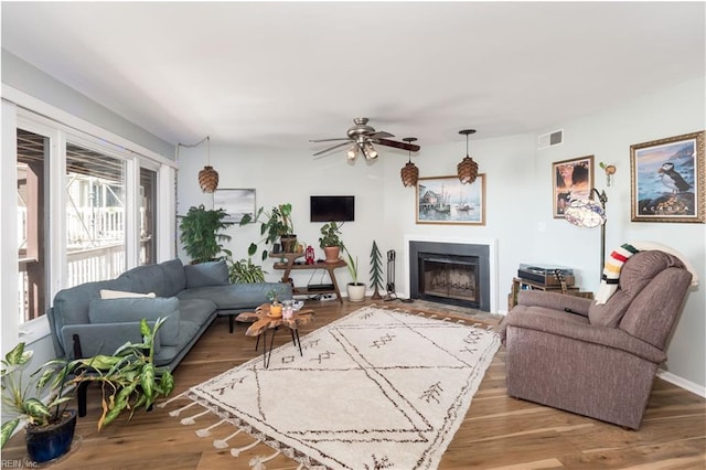 living room with ceiling fan and wood-type flooring