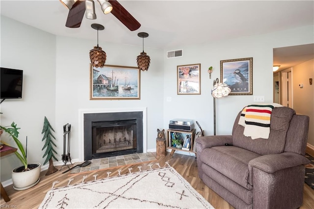 living room with hardwood / wood-style flooring and ceiling fan