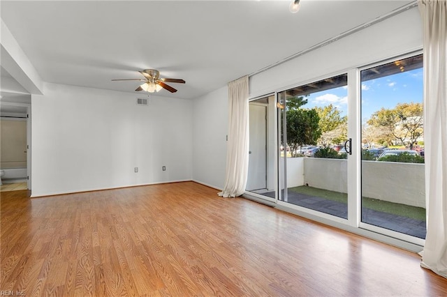 unfurnished room with ceiling fan and light hardwood / wood-style floors