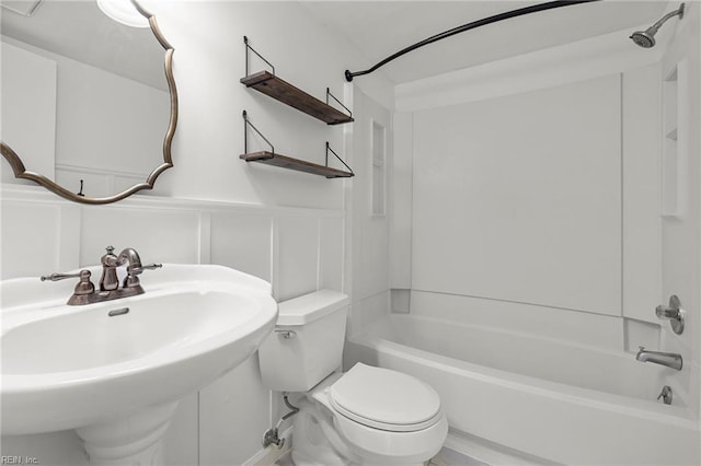 full bathroom with sink, washtub / shower combination, and toilet