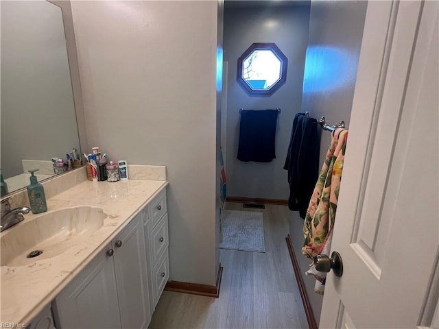 bathroom featuring vanity and hardwood / wood-style floors