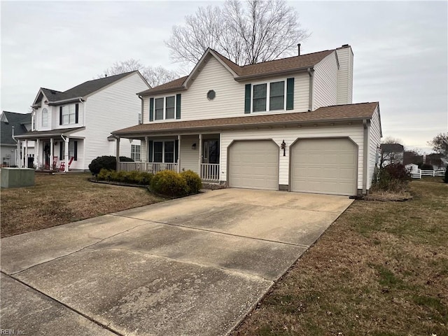 view of front of property featuring a garage, a front lawn, and covered porch