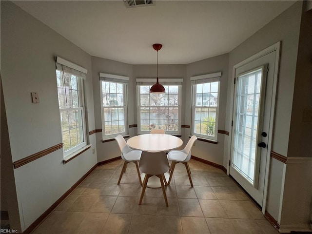 tiled dining area with a healthy amount of sunlight