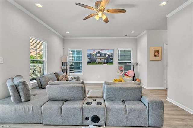 living room featuring hardwood / wood-style flooring, ceiling fan, and ornamental molding