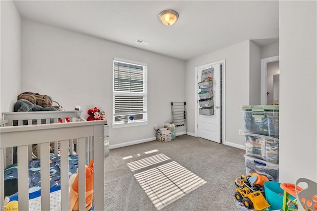 bedroom featuring a crib and carpet floors