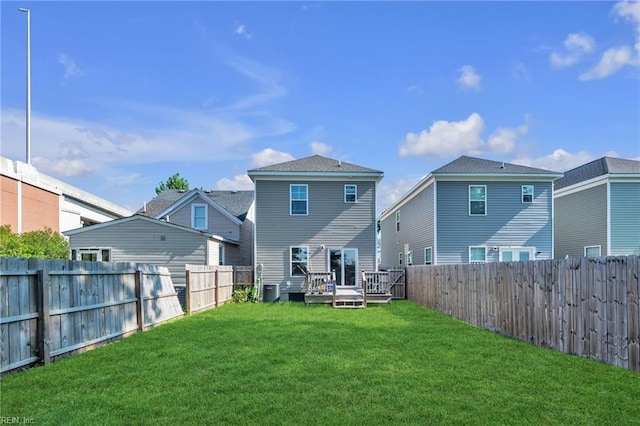 back of house featuring a yard and a deck