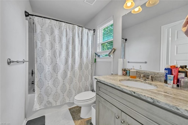 full bathroom with shower / bath combination with curtain, vanity, and toilet