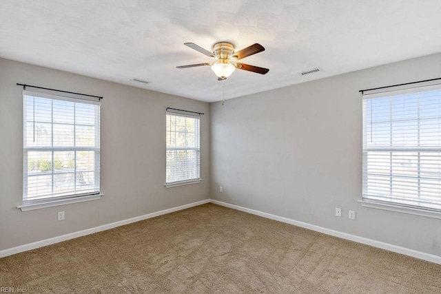 empty room with ceiling fan and carpet