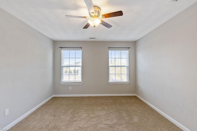 empty room featuring light colored carpet and ceiling fan