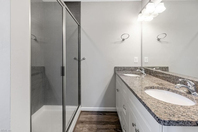 bathroom with vanity, a shower with door, and hardwood / wood-style floors