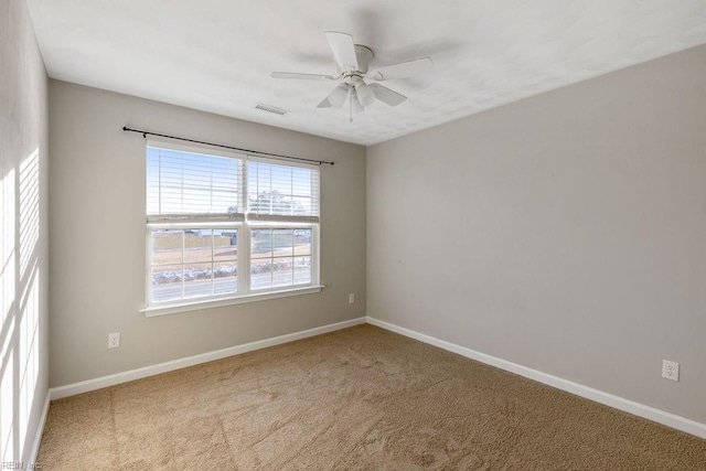 carpeted spare room with ceiling fan