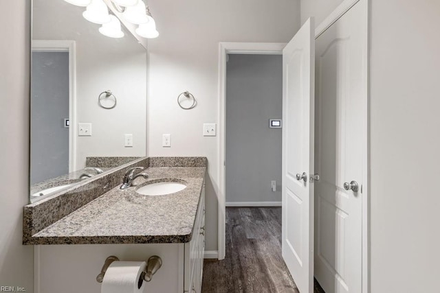 bathroom with vanity, hardwood / wood-style floors, and a notable chandelier