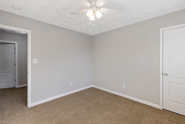 unfurnished room with ceiling fan and light carpet