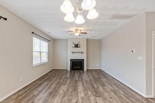 unfurnished living room with wood-type flooring and ceiling fan