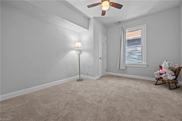 unfurnished room featuring light carpet and ceiling fan