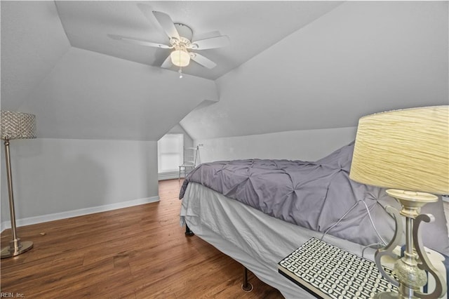 bedroom with ceiling fan, lofted ceiling, and hardwood / wood-style floors