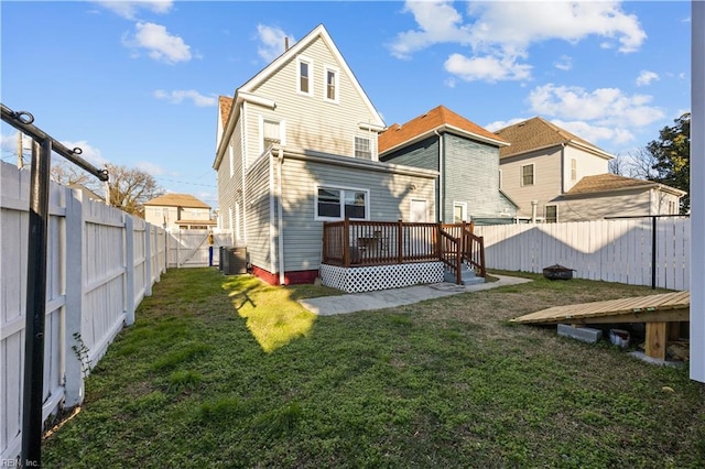 back of house featuring central AC unit, a yard, and a deck