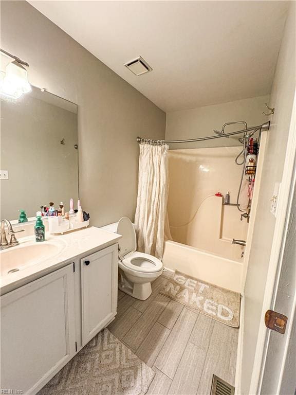 full bathroom with vanity, toilet, and shower / tub combo with curtain