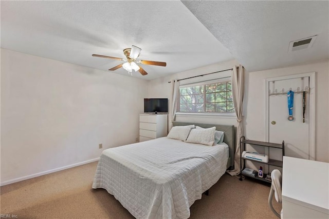 bedroom featuring ceiling fan, carpet flooring, and a textured ceiling